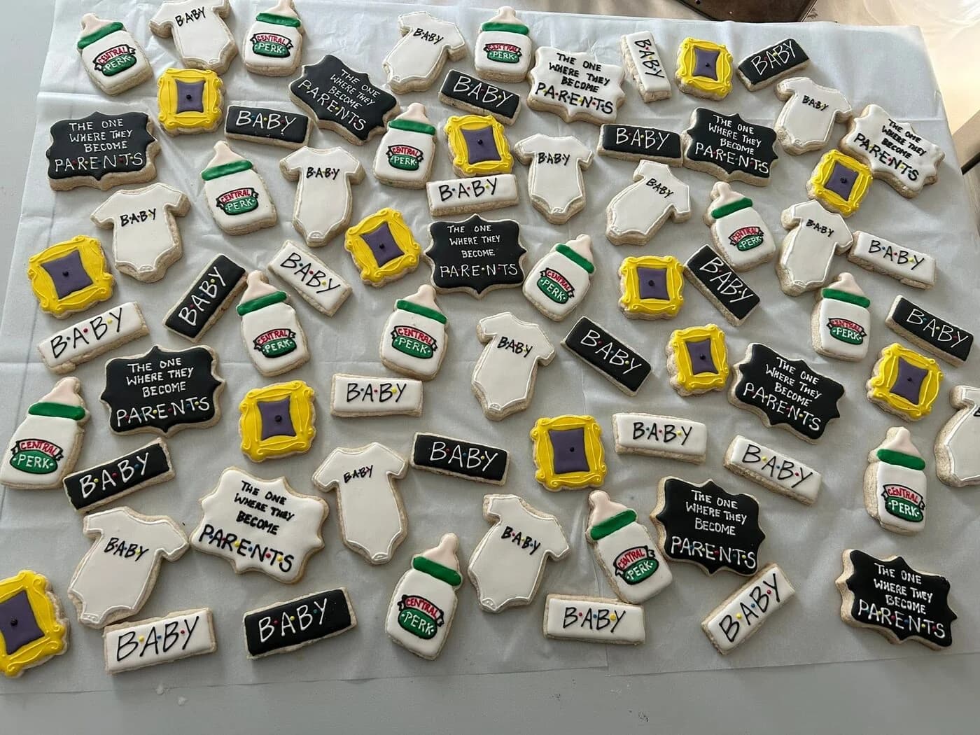 Friends TV show themed baby shower cookies — Central Perk, baby bottles, 'the one where they become parents' plaques