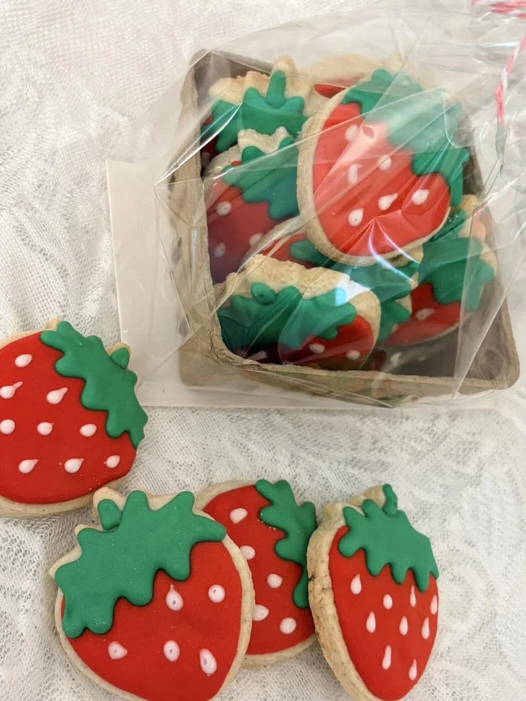 Strawberry-shaped decorated sugar cookies in a gift package