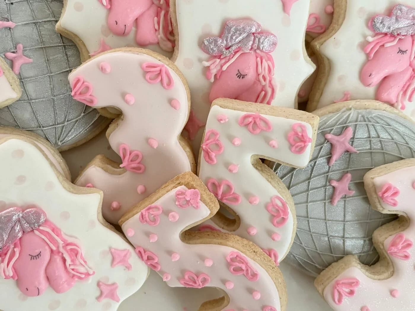 Pink and silver unicorn birthday cookies with disco balls and the number five